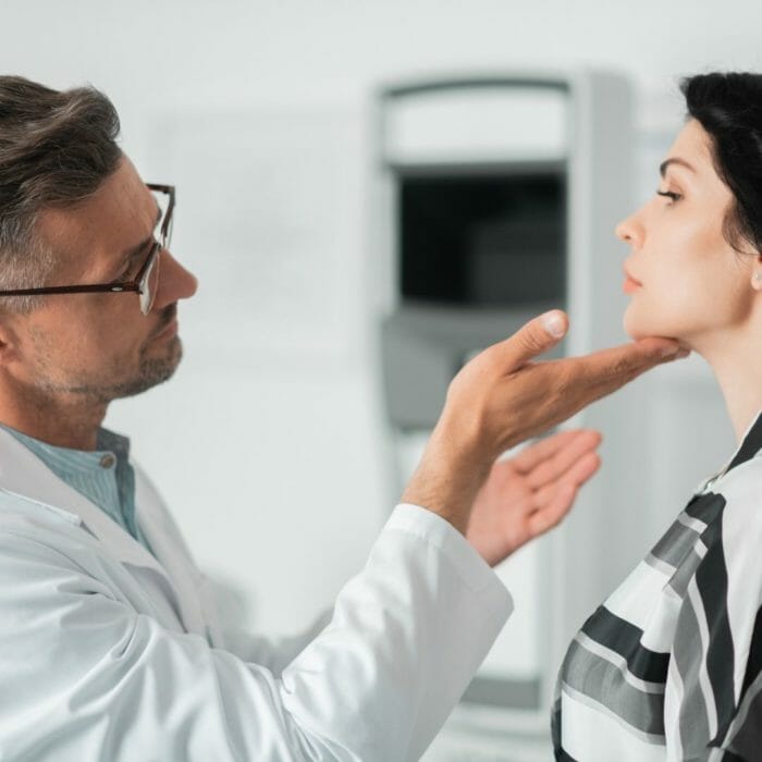 Cosmetic surgeon examining patient face for cosmetic surgery.